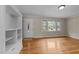 Inviting living room featuring hardwood floors, built-in shelving, and plenty of natural light at 203 W Boundary St, Cary, NC 27513