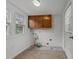 Utility room featuring cabinets, plumbing and paint cans at 203 W Boundary St, Cary, NC 27513