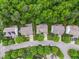 High-angle aerial view showcases homes with manicured lawns and lush green trees in a quiet neighborhood at 205 Slate Blue Pl, Cary, NC 27519