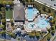 Aerial view of community amenities with pool, tennis courts, clubhouse, playground, and parking at 205 Slate Blue Pl, Cary, NC 27519