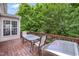 Wooden deck featuring a dining set and grill, perfect for enjoying the backyard scenery at 205 Slate Blue Pl, Cary, NC 27519
