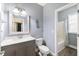 Well-lit bathroom featuring a single vanity with shaker cabinets and a shower-tub combo at 205 Slate Blue Pl, Cary, NC 27519