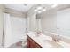 Bathroom with double sink vanity, shower and tub combination, with wood look vinyl flooring at 205 Slate Blue Pl, Cary, NC 27519