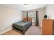 Bedroom with neutral walls, carpet, window with blinds, and wooden dresser at 205 Slate Blue Pl, Cary, NC 27519