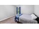 Bedroom with neutral walls, carpet, and a window with blue curtains at 205 Slate Blue Pl, Cary, NC 27519