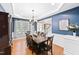 Formal dining room with hardwood floors, stylish chandelier, and a large table with seating for ten at 205 Slate Blue Pl, Cary, NC 27519