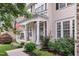 Charming front porch with an American flag, rocking chair, and beautifully landscaped garden at 205 Slate Blue Pl, Cary, NC 27519