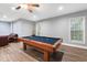 Game room featuring a pool table under a ceiling fan with a leather sofa in the background at 205 Slate Blue Pl, Cary, NC 27519