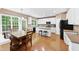 Spacious kitchen with white cabinets, hardwood floors, and a dining area perfect for Gathering meals at 205 Slate Blue Pl, Cary, NC 27519