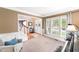 Bright living room with large windows, neutral decor, and a view of the entryway and staircase at 205 Slate Blue Pl, Cary, NC 27519