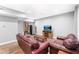 Comfortable living area with leather seating, a bookshelf, a mini refrigerator, and a TV at 205 Slate Blue Pl, Cary, NC 27519