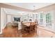 Open concept living room features wood floors, a fireplace, a large TV, and access to the kitchen and dining area at 205 Slate Blue Pl, Cary, NC 27519