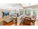Open concept living room features wood floors, a fireplace, a large TV, and access to the kitchen and dining area at 205 Slate Blue Pl, Cary, NC 27519