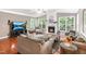 Open concept living room features wood floors, a fireplace, a large TV, and access to the kitchen and dining area at 205 Slate Blue Pl, Cary, NC 27519