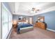 Spacious main bedroom featuring a ceiling fan and a large window letting in natural light at 205 Slate Blue Pl, Cary, NC 27519