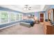 Spacious main bedroom with tray ceiling, large windows, and sitting area at 205 Slate Blue Pl, Cary, NC 27519