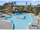 Beautiful aerial view of a community pool with a lighthouse-themed slide, beach entry, and island at 205 Slate Blue Pl, Cary, NC 27519