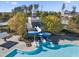 Unique lighthouse-themed water slide spills into the neighborhood pool, inviting endless summer fun at 205 Slate Blue Pl, Cary, NC 27519