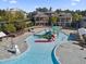 Community pool with a splash pad and kiddie slide surrounded by brick townhomes at 205 Slate Blue Pl, Cary, NC 27519