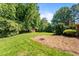 Well-maintained backyard with mature trees and a shed at 2053 Nottingham Ln, Burlington, NC 27215