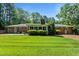 Expansive backyard with mature trees and a lush, green lawn at 2053 Nottingham Ln, Burlington, NC 27215