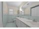 Bright bathroom features double sinks, tiled walls, and a large mirror at 2053 Nottingham Ln, Burlington, NC 27215