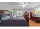 Spacious bedroom has a ceiling fan, bright windows, and wood-look flooring at 2053 Nottingham Ln, Burlington, NC 27215