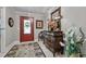 Elegant foyer features a decorative door, tiled floor, and ornate mirror on top of a wood dresser at 2053 Nottingham Ln, Burlington, NC 27215