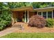 Inviting brick front porch with steps, decorative plants, and stylish accents, creating a warm entrance at 2053 Nottingham Ln, Burlington, NC 27215