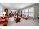 Bright living room offers ample seating, large windows, and seamless transition to the dining area at 2053 Nottingham Ln, Burlington, NC 27215