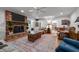 Spacious living room features a brick fireplace, wooden floors, and comfortable seating arrangement at 2053 Nottingham Ln, Burlington, NC 27215
