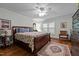 Comfortable bedroom with hardwood floors, a ceiling fan, and a large decorative bed at 2053 Nottingham Ln, Burlington, NC 27215