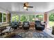 Bright sunroom with large windows, tile floor, and comfortable seating to enjoy the backyard view at 2053 Nottingham Ln, Burlington, NC 27215