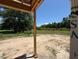 Open-air back porch showcasing spacious green backyard and surrounding wooded landscape at 209 Atkins Rd, Cameron, NC 28326
