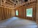 Unfinished bedroom featuring two windows for natural light in this new home construction at 209 Atkins Rd, Cameron, NC 28326