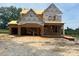 Under-construction home featuring a two-story design with a framed facade, showcasing future architectural details at 209 Atkins Rd, Cameron, NC 28326