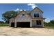 Unfinished two-story home with a two-car garage awaiting new construction to be completed at 209 Atkins Rd, Cameron, NC 28326