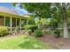 Picturesque backyard with lush greenery, mature trees, and manicured garden beds at 241 Serenity Hill Circle Cir, Chapel Hill, NC 27516
