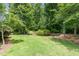 Expansive backyard with lush lawn, mature trees, and peaceful surroundings at 241 Serenity Hill Circle Cir, Chapel Hill, NC 27516