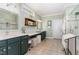 Bright bathroom with dual vanity sinks, granite countertops, and built-in towel racks at 241 Serenity Hill Circle Cir, Chapel Hill, NC 27516