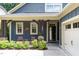 Charming front porch with blue siding, rustic wooden beams, and inviting pink chairs at 241 Serenity Hill Circle Cir, Chapel Hill, NC 27516