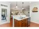 Kitchen island with sink and stainless steel dishwasher overlooking dining and living areas at 241 Serenity Hill Circle Cir, Chapel Hill, NC 27516