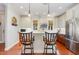 Modern kitchen with a breakfast bar, stainless steel appliances, and stylish pendant lighting at 241 Serenity Hill Circle Cir, Chapel Hill, NC 27516