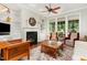 Cozy living room featuring a fireplace, custom shelving, and large windows for natural light at 241 Serenity Hill Circle Cir, Chapel Hill, NC 27516