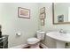 Half-bathroom featuring pedestal sink, toilet, and decorative mirror at 241 Serenity Hill Circle Cir, Chapel Hill, NC 27516