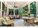 Inviting sunroom featuring wicker furniture, natural light, and serene backyard views at 241 Serenity Hill Circle Cir, Chapel Hill, NC 27516