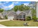 Charming stone and vinyl siding home with manicured front yard and attached two car garage at 2634 Yellow Pine Rd, Raleigh, NC 27616