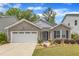 Charming single-story home featuring stone accents, a two-car garage, and a well-manicured lawn with beautiful landscaping at 2634 Yellow Pine Rd, Raleigh, NC 27616