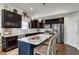 Well-equipped kitchen with dark cabinets, stainless steel appliances, and a central island for seating at 2634 Yellow Pine Rd, Raleigh, NC 27616