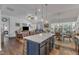Open concept kitchen island with granite countertop and bar seating overlooking the living area at 2634 Yellow Pine Rd, Raleigh, NC 27616